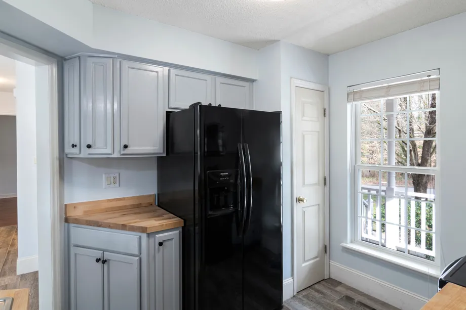 Black refrigerator in a bright home kitchen